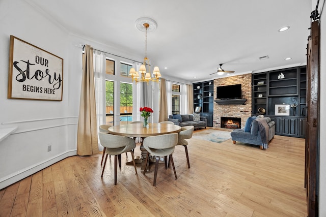 2320 Table Rock Ct, Arlington, TX 76006 - dining space featuring a brick fireplace, built in features, a chandelier, light wood finished floors, and ceiling fan