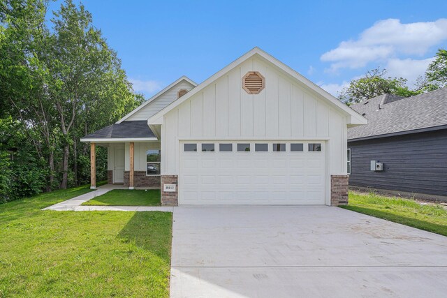 4041/2 Evans St, Cleburne, TX 76031 - ranch-style house featuring board and batten siding, an attached garage, driveway, a front yard, and brick siding