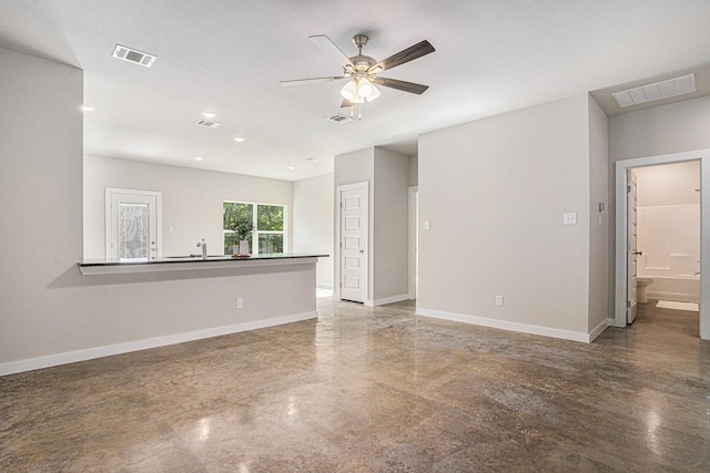 4041/2 Evans St, Cleburne, TX 76031 - unfurnished living room with concrete flooring, a ceiling fan, and baseboards
