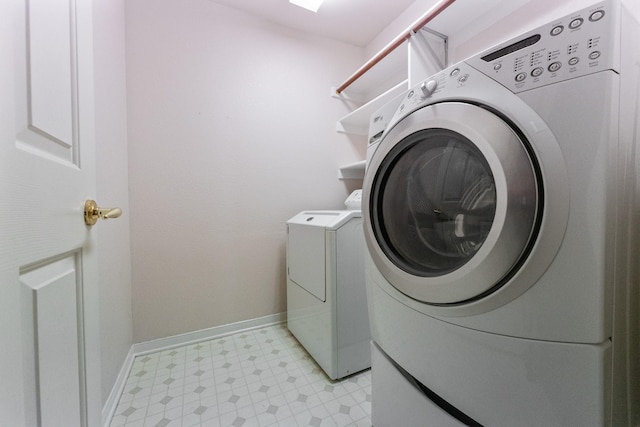 7601 Jennifer Ln, Frisco, TX 75034 - clothes washing area with light floors, washer and clothes dryer, and baseboards
