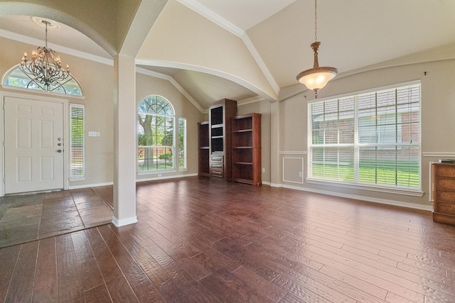 7601 Jennifer Ln, Frisco, TX 75034 - foyer featuring dark wood-style flooring, a chandelier, arched walkways, baseboards, and high vaulted ceiling