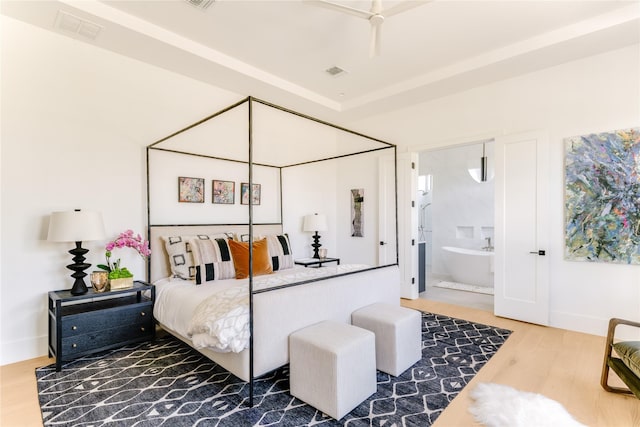 9895 Kingsway Ave, Dallas, TX 75230 - bedroom with wood finished floors and ensuite bath