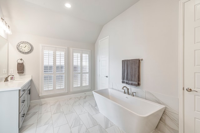 2826 Shane Dr, Midlothian, TX 76065 - bathroom featuring vaulted ceiling, a freestanding tub, vanity, marble finish flooring, and recessed lighting