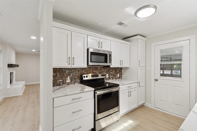 320 Allenwood Dr, Princeton, TX 75407 - kitchen with stainless steel appliances, light wood finished floors, decorative backsplash, white cabinetry, and baseboards