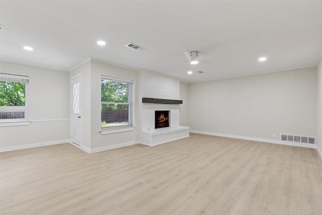 320 Allenwood Dr, Princeton, TX 75407 - unfurnished living room with light wood-type flooring, a fireplace, a ceiling fan, crown molding, and baseboards