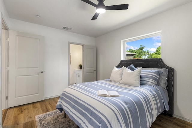 1900 Sussex Dr, Garland, TX 75041 - bedroom with wood finished floors, ceiling fan, and ensuite bathroom