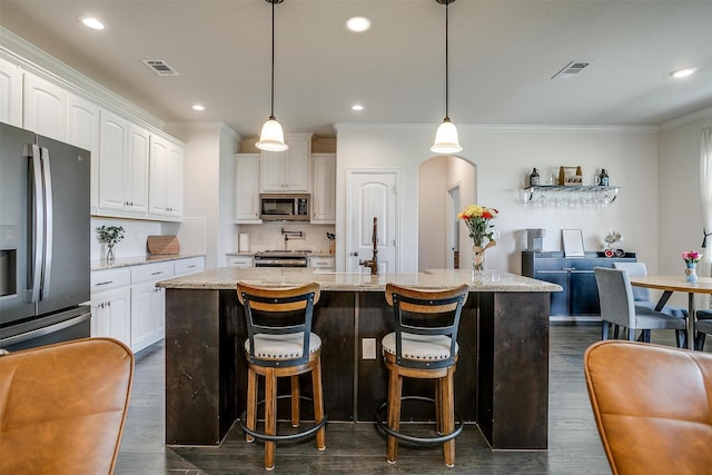 340 Sanger Dr, Springtown, TX 76082 - kitchen with appliances with stainless steel finishes, ornamental molding, white cabinets, dark wood-style flooring, and recessed lighting