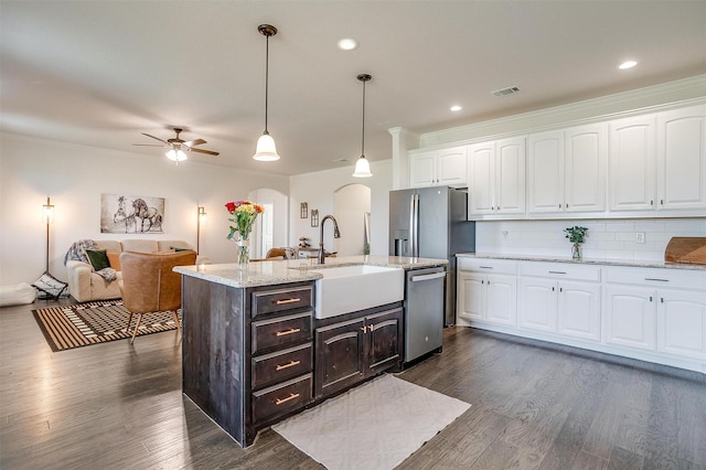 340 Sanger Dr, Springtown, TX 76082 - kitchen featuring a sink, dishwasher, arched walkways, white cabinetry, and ornamental molding