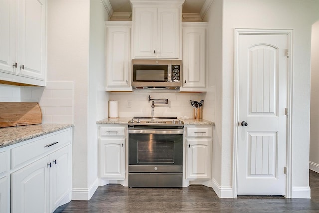 340 Sanger Dr, Springtown, TX 76082 - kitchen featuring appliances with stainless steel finishes, white cabinets, decorative backsplash, and baseboards