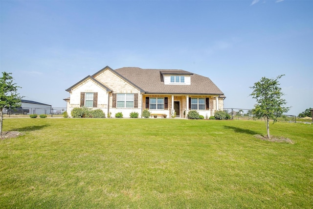 340 Sanger Dr, Springtown, TX 76082 - view of front facade with a front yard, stone siding, covered porch, and a shingled roof