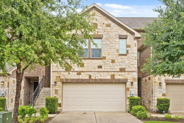 5542 Yellowstone Rd, The Colony, TX 75056 - view of front of property featuring stone siding, concrete driveway, and a garage