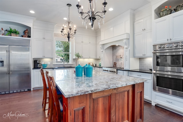 152 Sand Beach Blvd, Shreveport, LA 71105 - kitchen featuring stainless steel appliances, a chandelier, dark wood-style floors, white cabinetry, and recessed lighting