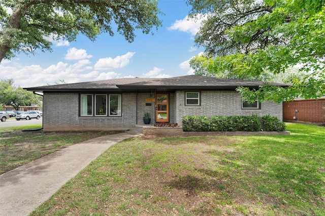 2137 Lenamon St, Waco, TX 76710 - view of front of home with brick siding and a front lawn