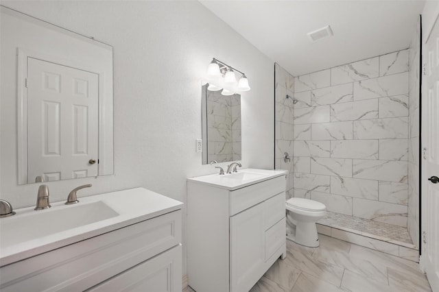 5605 Santa Fe Trl, Haltom City, TX 76148 - full bath with marble look tile flooring, two vanities, tiled shower, and toilet