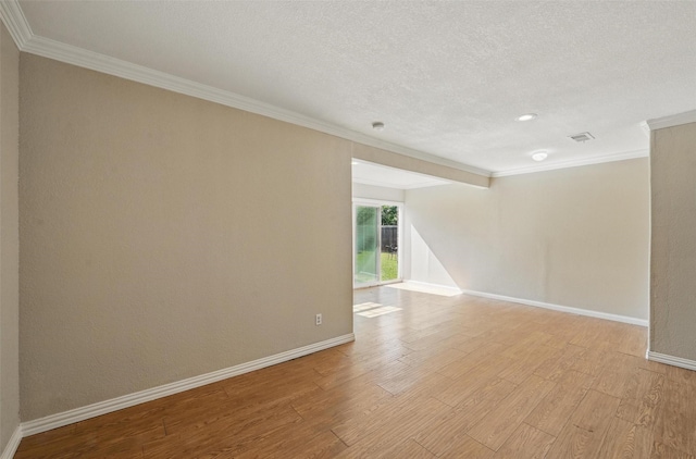5605 Santa Fe Trl, Haltom City, TX 76148 - unfurnished room featuring crown molding, light wood-type flooring, baseboards, a textured ceiling, and recessed lighting