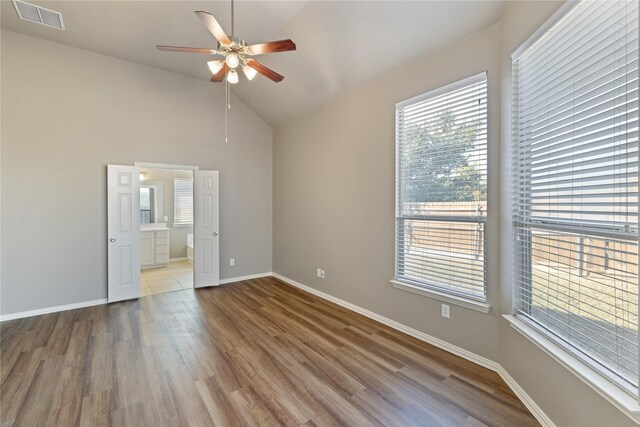 1212 Wheatear, Little Elm, TX 75068 - unfurnished bedroom with wood finished floors, vaulted ceiling, baseboards, connected bathroom, and ceiling fan