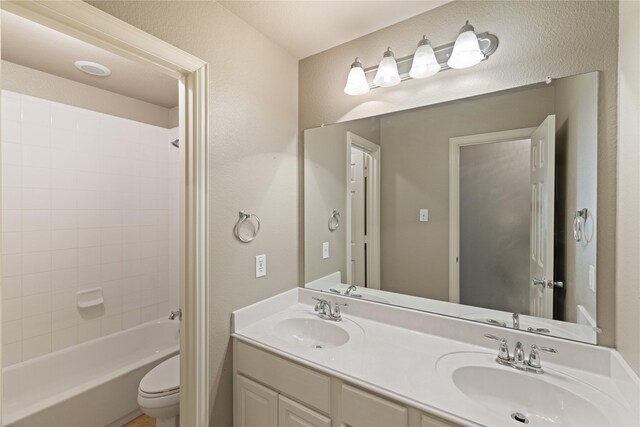 1212 Wheatear, Little Elm, TX 75068 - full bathroom with toilet, double vanity,  shower combination, and a textured wall
