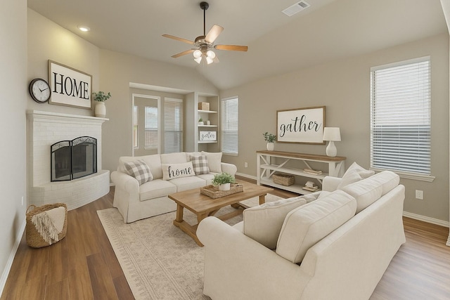1212 Wheatear, Little Elm, TX 75068 - living area with baseboards, ceiling fan, wood finished floors, vaulted ceiling, and a brick fireplace