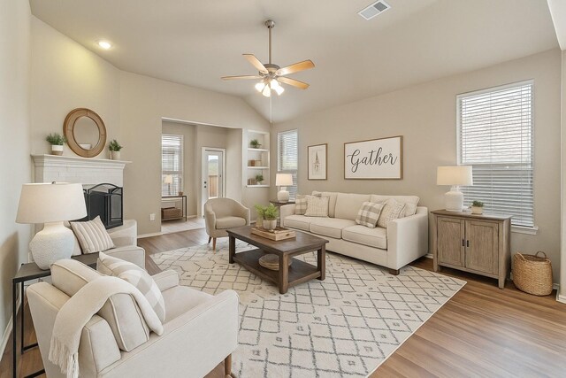 1212 Wheatear, Little Elm, TX 75068 - living area featuring ceiling fan, light wood-style flooring, built in features, plenty of natural light, and lofted ceiling