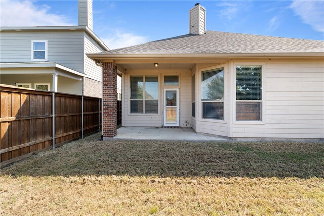 1212 Wheatear, Little Elm, TX 75068 - rear view of property featuring a patio, a chimney, and a shingled roof