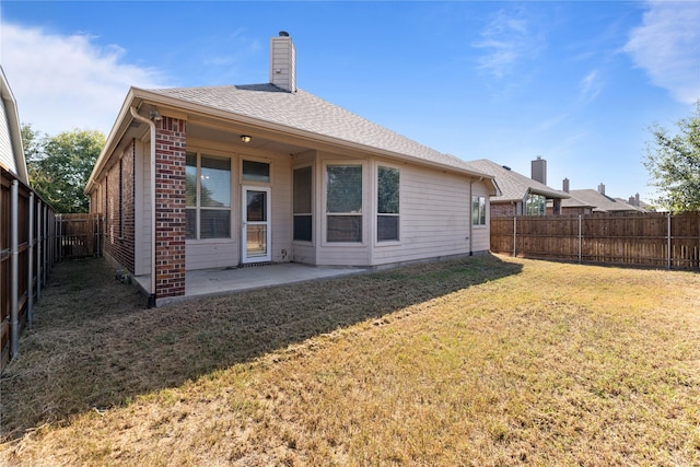 1212 Wheatear, Little Elm, TX 75068 - back of property with brick siding, a patio, and a chimney