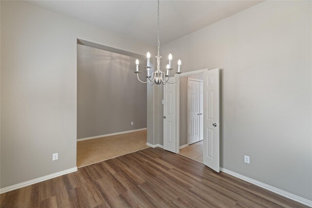 1212 Wheatear, Little Elm, TX 75068 - unfurnished room with a chandelier, wood finished floors, and baseboards