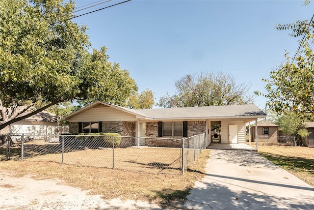 97 Wade St, Nocona, TX 76255 - single story home with brick siding, a carport, concrete driveway, and a fenced front yard