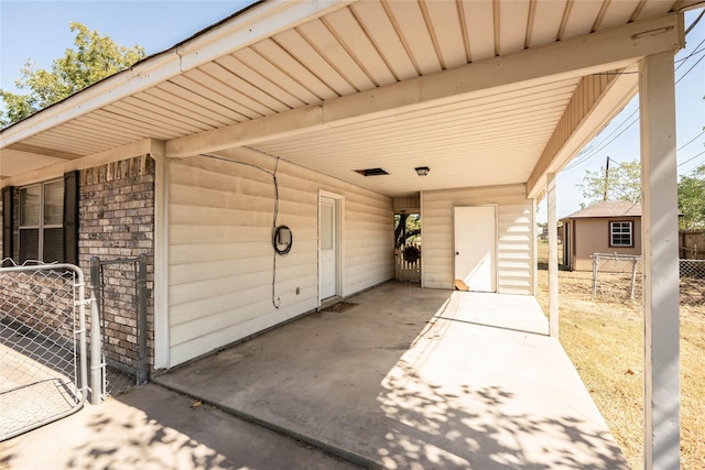 97 Wade St, Nocona, TX 76255 - view of patio / terrace with a gate, fence, and an attached carport