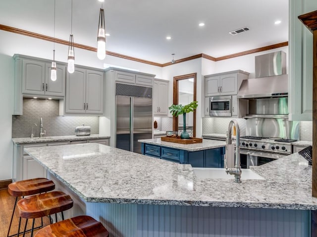 6302 Waggoner Dr, Dallas, TX 75230 - kitchen with built in appliances, wall chimney range hood, a kitchen island, backsplash, and a sink