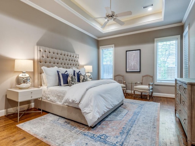 6302 Waggoner Dr, Dallas, TX 75230 - bedroom with a raised ceiling, wood finished floors, baseboards, ornamental molding, and a ceiling fan