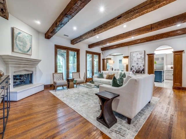 6302 Waggoner Dr, Dallas, TX 75230 - living room featuring wood finished floors, recessed lighting, beam ceiling, a glass covered fireplace, and baseboards