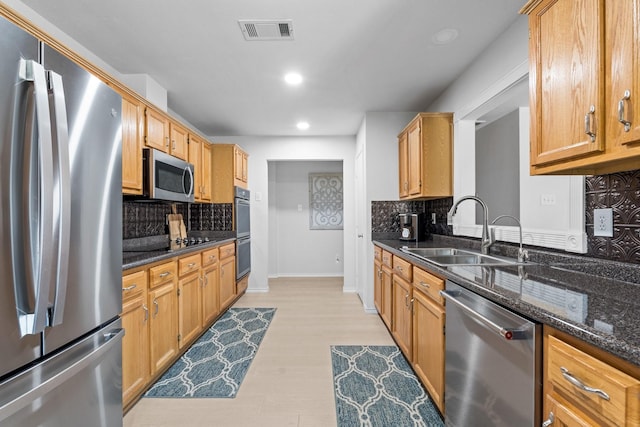 1930 Copper Ridge Cir, Rockwall, TX 75032 - kitchen featuring appliances with stainless steel finishes, a sink, tasteful backsplash, recessed lighting, and dark stone counters