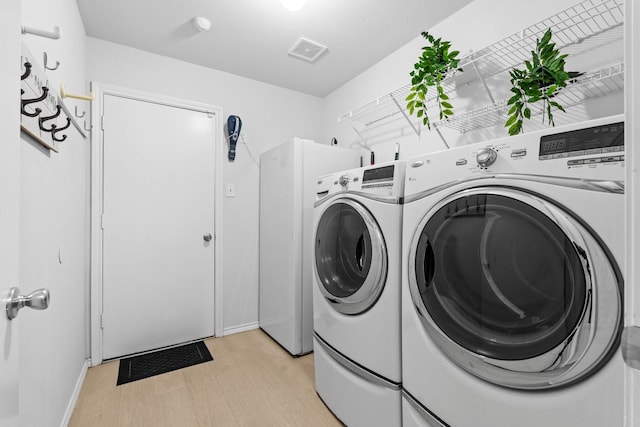 1930 Copper Ridge Cir, Rockwall, TX 75032 - washroom with washer and dryer, light wood-style floors, and baseboards