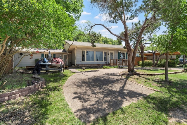 117 Linda Lee Loop, Whitney, TX 76692 - rear view of property with driveway, a deck, and a yard