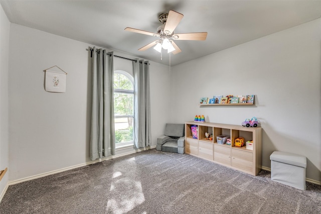 playroom featuring ceiling fan, carpet flooring, and baseboards