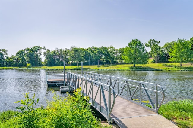 dock featuring view of scattered trees and a water view