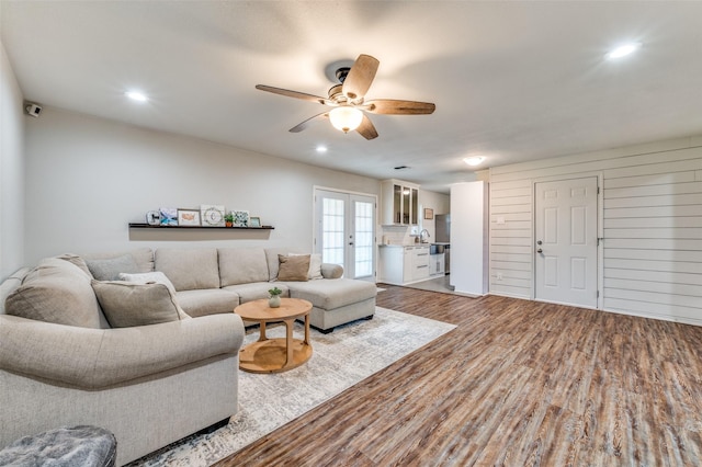 living room with wood finished floors, ceiling fan, recessed lighting, and french doors