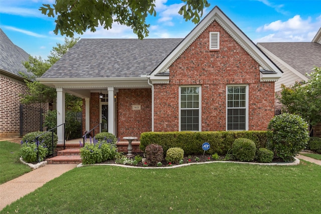 8621 Nichols Way N, Richland Hills, TX 76180 - view of front facade with brick siding, roof with shingles, a front yard, and a porch