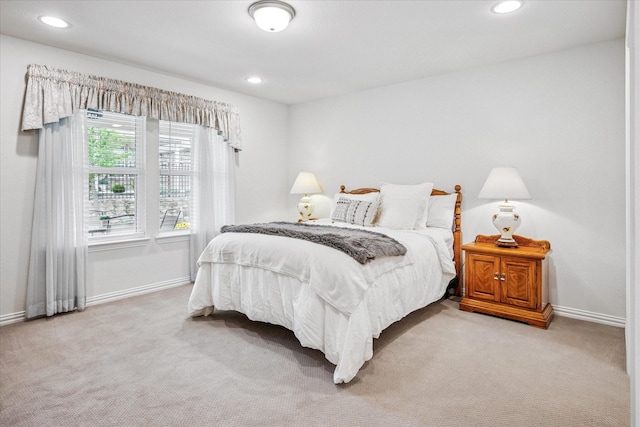 bedroom featuring light carpet, baseboards, and recessed lighting