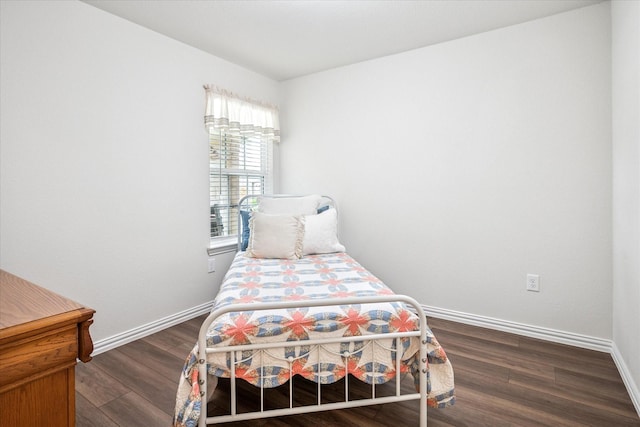 bedroom with wood finished floors and baseboards