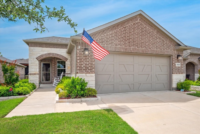 9109 Water Willow Way, Mckinney, TX 75071 - french country style house with brick siding, an attached garage, driveway, stone siding, and a shingled roof
