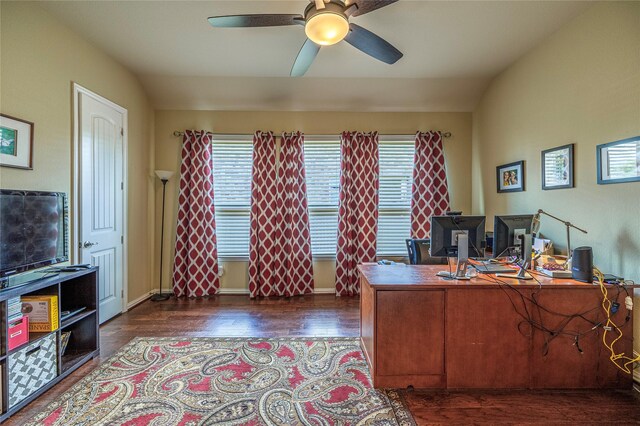 home office featuring ceiling fan, dark wood finished floors, and vaulted ceiling