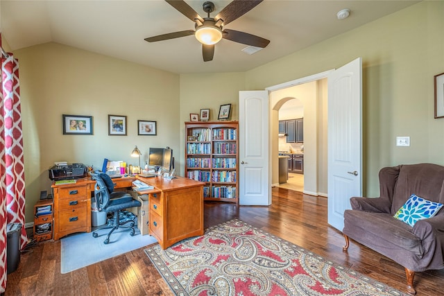 office area featuring arched walkways, hardwood / wood-style floors, ceiling fan, and vaulted ceiling