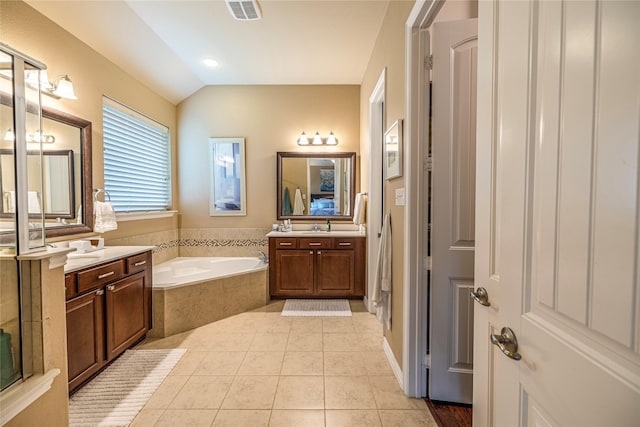 bathroom with a bath, tile patterned floors, two vanities, and vaulted ceiling