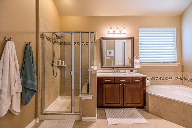 full bath featuring a stall shower, vanity, a garden tub, and tile patterned flooring