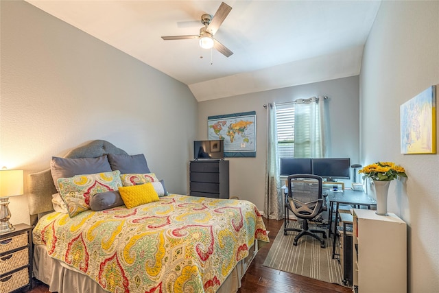 bedroom with dark wood-style flooring, lofted ceiling, a desk, and ceiling fan