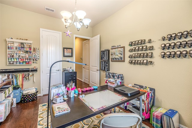 home office with a chandelier and wood finished floors