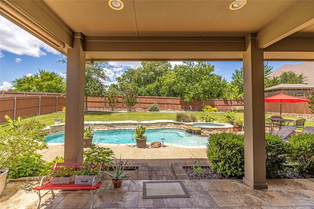 view of pool with an in-ground hot tub and a patio area