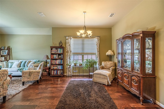sitting room featuring a chandelier and wood finished floors