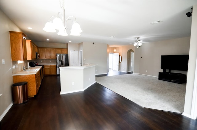 708 Flora Vista Ct, Arlington, TX 76002 - kitchen featuring stainless steel appliances, arched walkways, light countertops, a chandelier, and baseboards